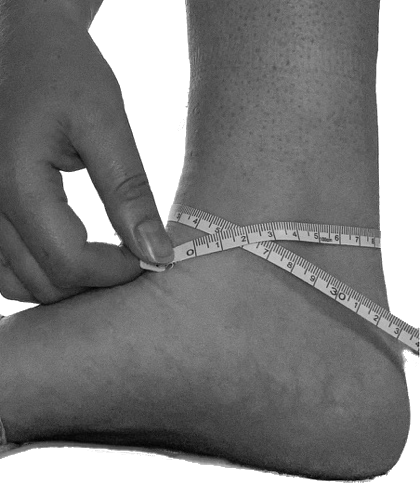 Foot being measured around the widest part of the ankle with a tape measure