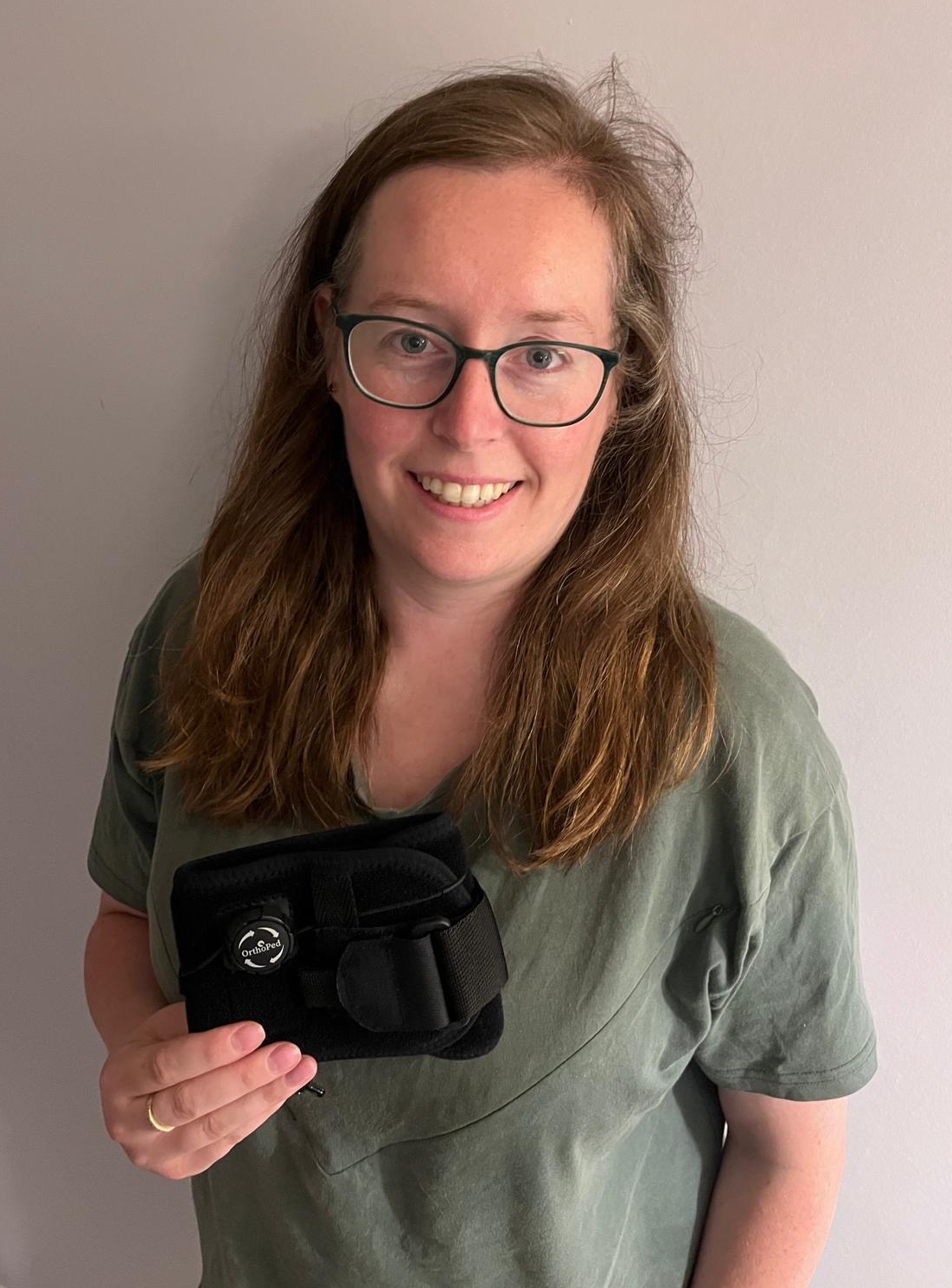 Claire Williamson holding the OrthoPed Foot Drop Splint