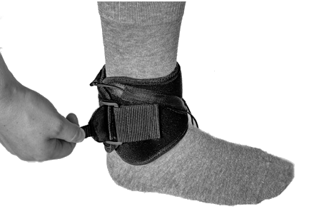 Velcro tab being folded back on itself to secure the splint